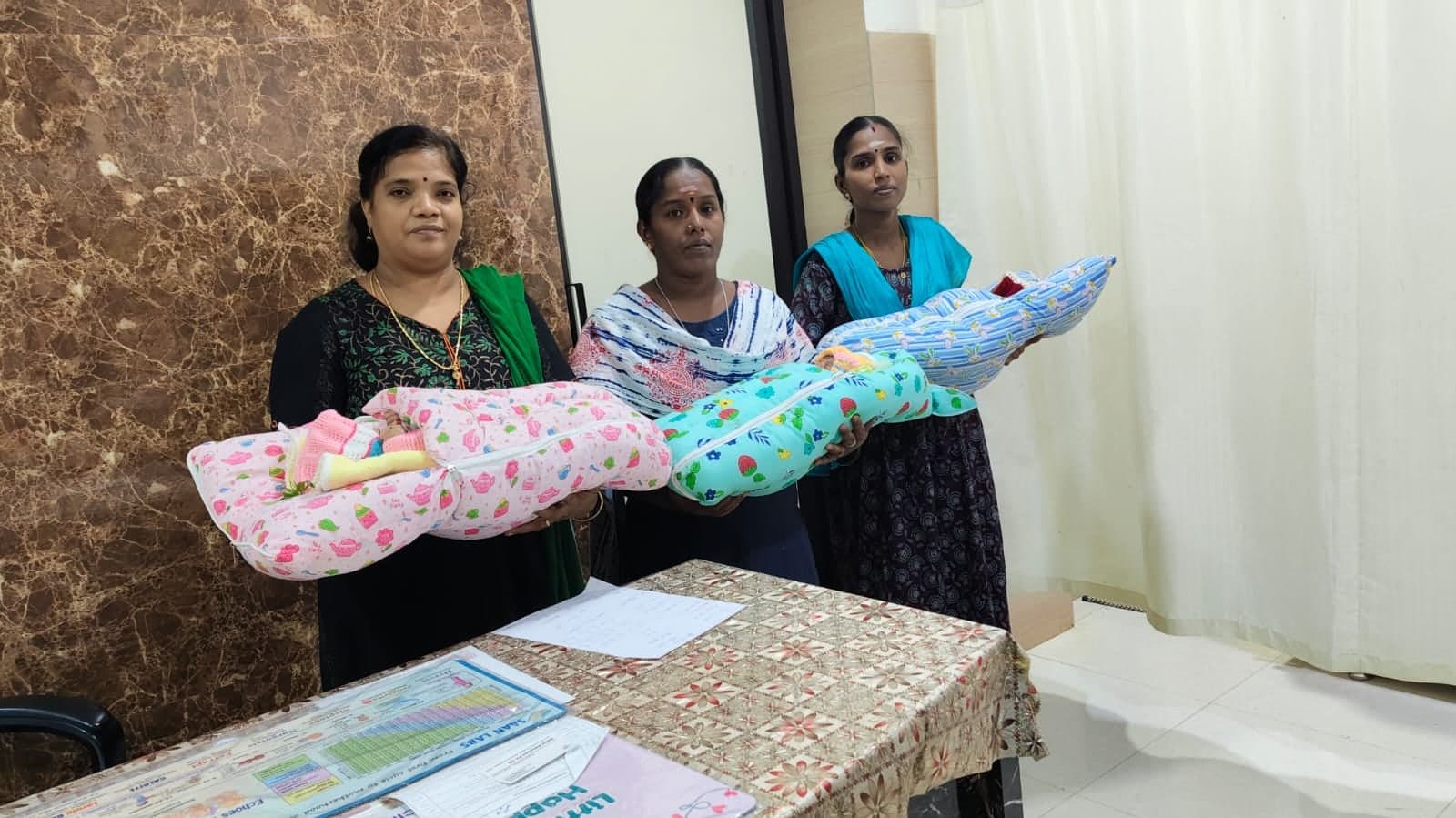 Staff and families with three newborn babies