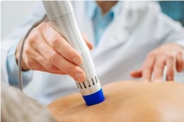 A clinician holding a treatment probe during a consultation
